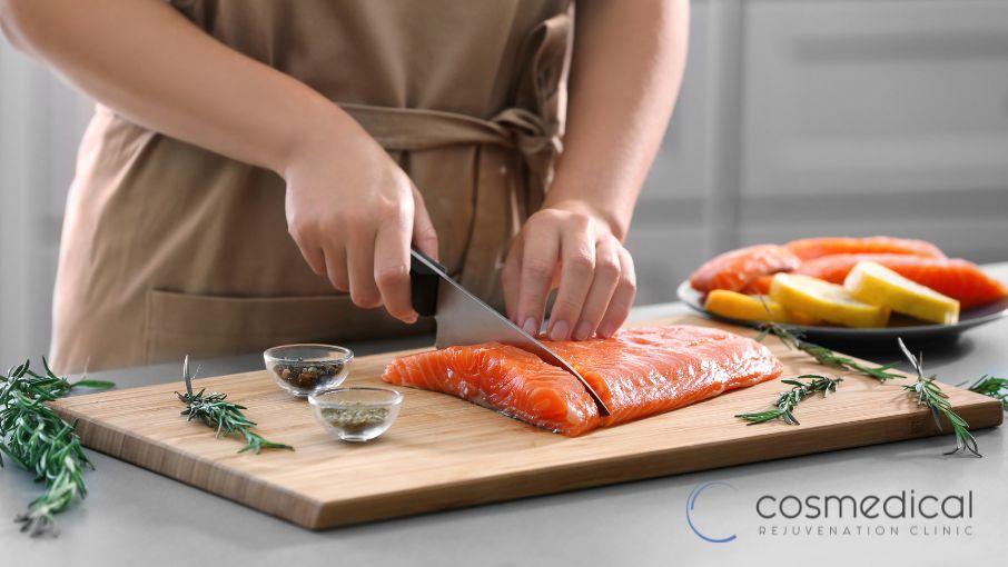 woman preparing salmon after breast augmentation